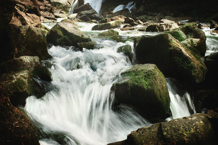 beautiful waterfall and rocks in river in europe mountains, travel explore concept