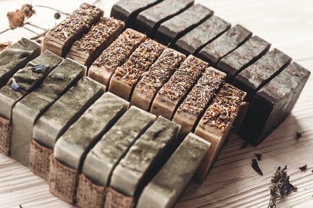 natural soap. handmade herbal soap with wildflowers, healing flowers, mint, dried lavender. eco natural product for skin care. healthy soap on white rustic background with dried herbsの写真素材