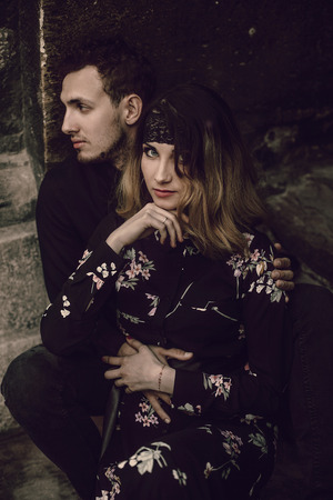 stylish gypsy couple in love posing in evening city street at old building. woman and man embracing, romantic french atmospheric moment. love mood. modern bride and groomの写真素材
