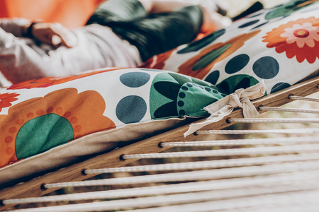 pillows on colorful stylish travel hammock in summer sunny park. resting, camping and relaxing outdoor, summer vacation and holiday. space for text. wanderlust and adventureの写真素材
