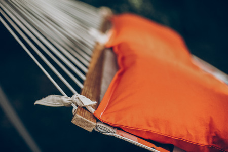 pillows on colorful stylish travel hammock in summer sunny park. resting, camping and relaxing outdoor, summer vacation and holiday. space for text. wanderlust and adventureの写真素材