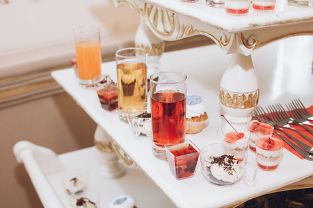 delicious juice and desserts sweet on table at wedding reception in restaurant. luxury catering. christmas feast. wedding candy barの写真素材