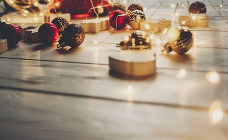 christmas magic moments. warm lights and simple ornaments and christmas trees  on white wood in...