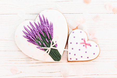 cookie hearts and lavender flowers on white rustic wooden background  flat lay. space for text. happy valentine's day or women's. happy mother's day greeting cardの写真素材