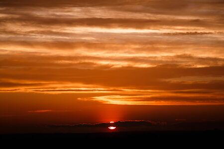 amazing sun at dusk clouds. sunset image. beautiful red cloudy sunset  in orange sky, dramatic view....