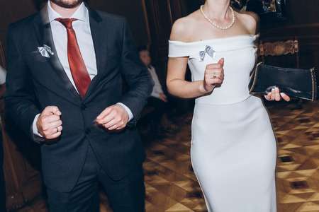 happy stylish people dancing and having fun at wedding reception in restaurant. guests dancing in light, people in motion at party in club. fun moments.の写真素材