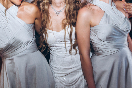 happy stylish bride and bridesmaids dancing and having fun at wedding reception in restaurant. guests dancing in light, people in motion at party in club. fun moments.の写真素材
