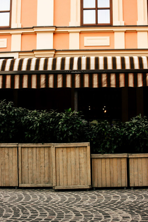 beautiful exterior of restaurant terrace in sunny street in european cityの写真素材