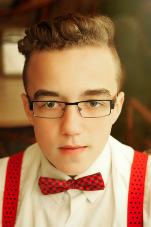 stylish hipster man portrait with glasses and bowtie in old center of europe city Lviv