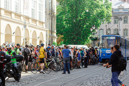 Lviv, Ukraine - May 6, 2017: cycling marathon VIII Lviv 100km ride, 425 bicycles, in the streets of the city. participants and athletes riding bikes and waiting for tram to passのeditorial素材