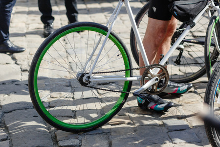 Lviv, Ukraine - May 6, 2017: cycling marathon VIII Lviv 100km ride, 425 bicycles, in the streets of the city. participants and athletes riding bikes. stylish green white wheel close upのeditorial素材