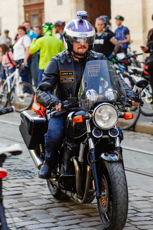 Lviv, Ukraine - May 6, 2017: cycling marathon VIII Lviv 100km ride, 425 bicycles, in the streets of the city. brutal man on stylish steel vintage motor bike, participants and athletes riding bikesのeditorial素材