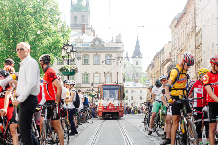 Lviv, Ukraine - May 6, 2017: cycling marathon VIII Lviv 100km ride, 425 bicycles, in the streets of the city. participants and athletes riding bikes and waiting for tram to passのeditorial素材