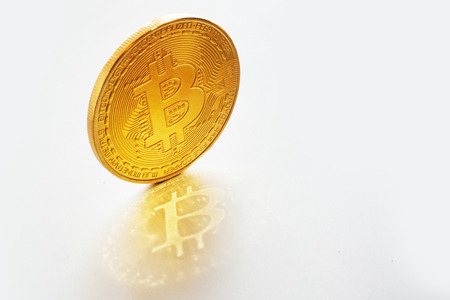 golden bitcoins on white background, isolated. digital currency,  bit coin, cryptocurrency concept. digital money with reflection, space for text. worldwide network currencyの写真素材