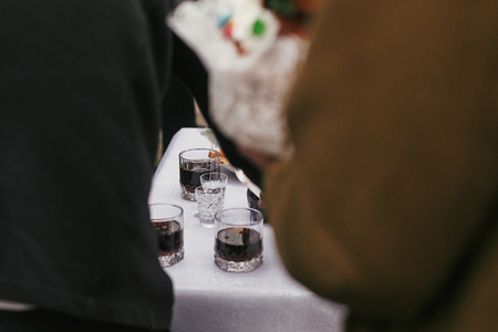 wedding table with alcohol drinks, vodka in glasses. people toasting at wedding reception. cateringの写真素材