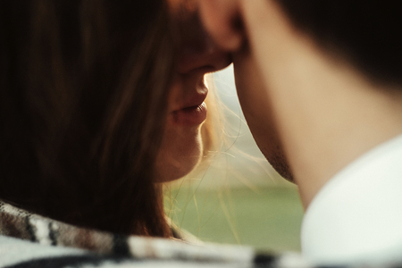 sensual beautiful bride's lips and groom neck, tender moment, honeymoon in mountainsの写真素材