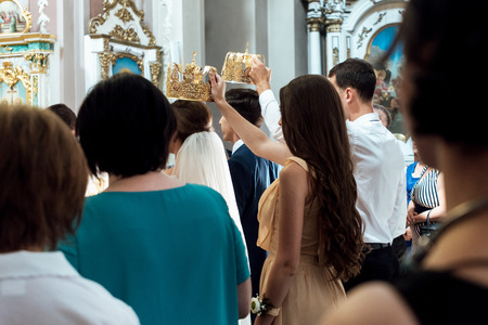 stylish luxury  bride and elegant groom, with crowns and candles, wedding ceremony