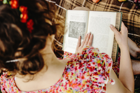 beautiful happy bride and stylish retro groom, reading books and relaxing, eating fruits,  picnic in sunny meadowの写真素材