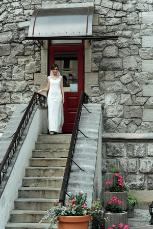 Stylish gorgeous happy bride starting to perform first dance with groom at the wedding receptionの写真素材