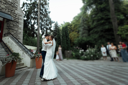 Stylish gorgeous happy bride and elegant groom performing their first dance at the wedding receptionの写真素材