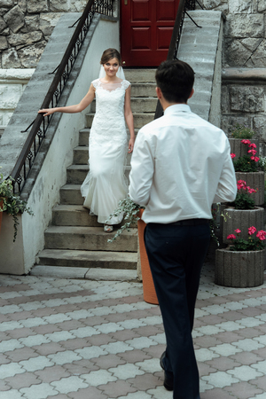 Stylish gorgeous happy bride and elegant groom performing their first dance at the wedding receptionの写真素材