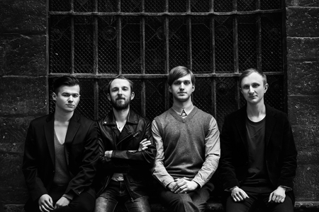 stylish handsome group of confident and successful men standing  on the background of city streetの写真素材