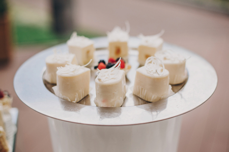 stylish candy bar with delicious modern mascarpone cakes, cookies, in pink and white colors. luxury catering in restaurant. wedding reception. modern sweet table at celebrationの写真素材