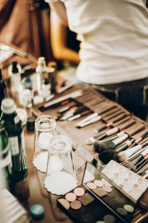 make-up concept. makeup set of brushes, powder,eyeshadows on table. artist making make up for bride in the morning. beauty and fashion imageの写真素材