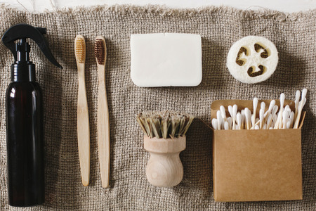 eco natural bamboo toothbrush,luffa, coconut soap,brushes,ear sticks on rustic background. zero waste flat lay. home essentials, plastic free items. sustainable lifestyle conceptの写真素材