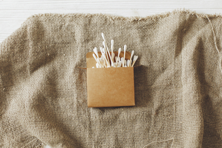 eco natural bamboo ear sticks flat lay on rustic background. sustainable lifestyle concept. zero waste, plastic free items. stop plastic pollution. reuse, reduce, recycle, refuseの写真素材