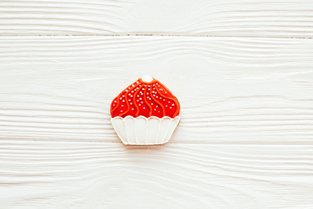 Red Cupcake icing cookie on white wood, flat lay with space for text. Delicious sweets. Happy Mothers day. Valentine day. Candy conceptの写真素材