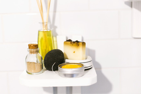 Zero waste bathroom concept. Eco natural shampoo, konjac sponge, fragrance oil, soap and ayurveda...
