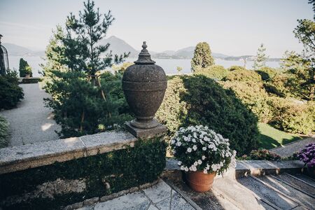 Beautiful view of stone landmarks and green trees and plants on Borromean Islands on Lago Maggiore, Italy. Exploring old architecture monuments in garden. Summer vacation in Europeの写真素材