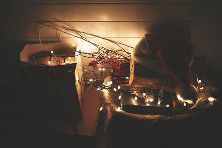 Christmas eve atmosphere. Merry Christmas. Happy Holidays. Stylish christmas gift boxes, santa hat,...