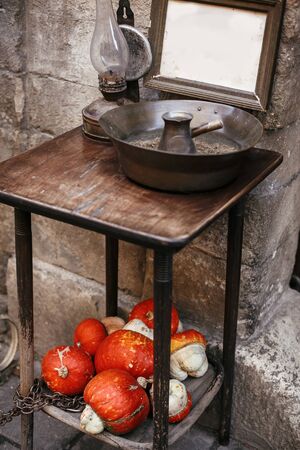 Pumpkins and squash in city street, holiday decorations store fronts and buildings. Halloween street...