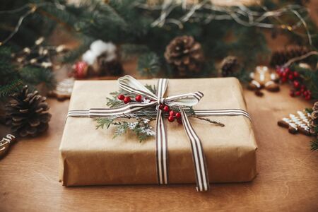 Stylish rustic christmas gift and pine branches