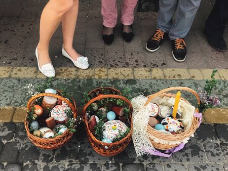 Easter baskets with stylish painted eggs, easter cake, ham,beets, butter, candle with boxwood...