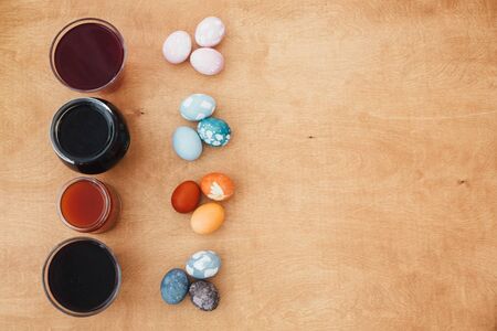 Natural dye easter eggs on wooden table with copy space. Pink eggs - with beetroot, turquoise - red...