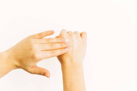 Hand applying moisturizing cream on skin after washing hands and using alcohol gel during virus...