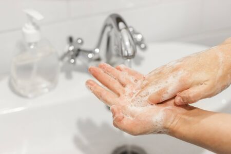 Rubbing palms, washing hands with antibacterial soap and in proper technique on background of...