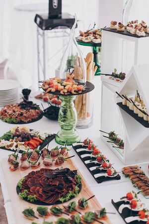 Christmas table feast. Delicious Italian delicatessen, prosciutto snacks, cheese and olives,...
