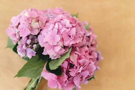 Hydrangea bouquet on rustic wooden background, top view. Beautiful pink and purple hydrangea flowers at home. Happy mothers dayの写真素材