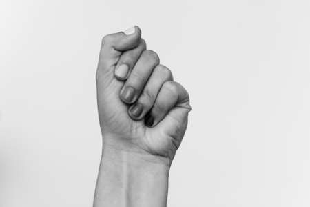 Protest. Blurred image of female fist protesting, black and white photo. Female hand raised up, strong and power concept. Women rights fight. Stop racismの写真素材