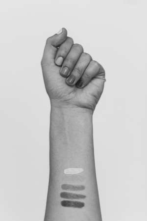 Protest. Female fist protesting, black and white photo. Female hand raised up, strong and power concept. Women rights fight, skin and race diversity. Stop racismの写真素材