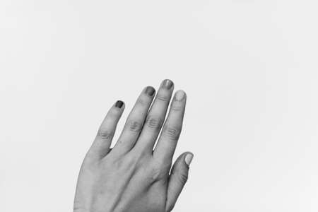 Female hand raised up, black and white photo. Female hand protesting, strong and power concept. Women rights fight. Stop racismの写真素材