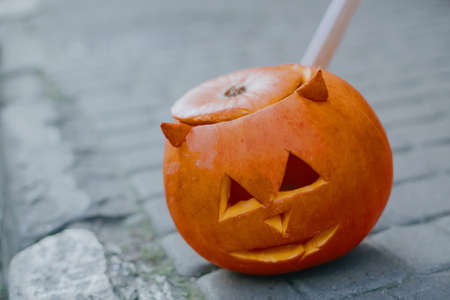 Halloween street decor. Jack-o'-lantern with scary face on street, modern festive decoration. Carved...