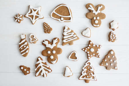 Christmas gingerbread cookies on white wooden background, flat lay. Tasty modern homemade...