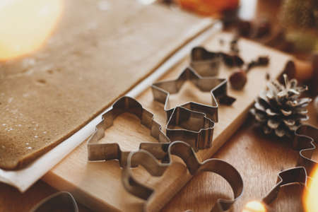 Making gingerbread cookies, Christmas holiday tradition, advent. Raw gingerbread dough, metal...