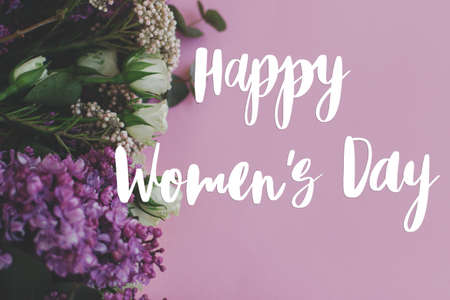 Happy womens day text on beautiful lilac and roses fresh colorful border on bright pink background....
