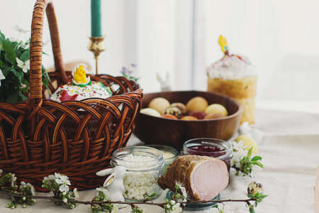 Traditional Easter food for blessing, homemade Easter bread, stylish easter eggs and blooming spring...